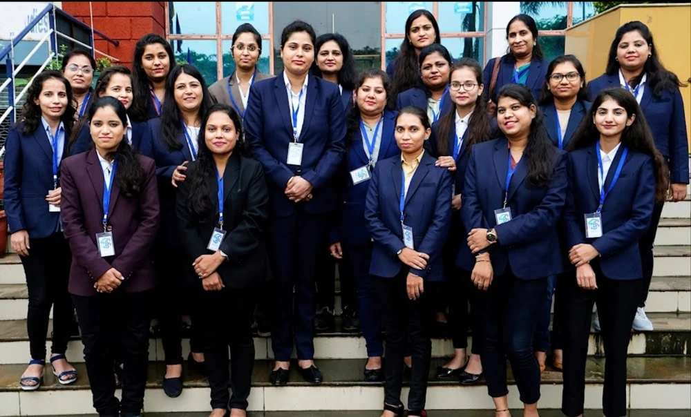 Women standing together on the steps outside an office building.